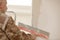 Builder using a trowel to add plaster. Plastering wall with putty-knife, close up image. Fixing wall surface and preparation for