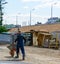 Builder worker carries a wheelbarrow