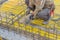 Builder worker gearing up steel rods for a concrete 2