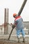 Builder worker pouring concrete