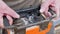 Builder worker working on remote control crane panel, moving building materials