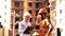 Builders communicate on the construction site. A woman in a white helmet communicates with a bearded man in an orange