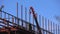 Builders fix iron beams with a crane. Frame construction. Moscow Russia April 14, 2022