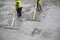 Builders leveling the concrete floor