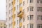 Builders paint the facade of a high-rise residential building