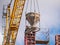 Builders pour concrete from the tank into the steel formwork. Monolithic construction of buildings. The crane holds the