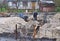 Builders pouring a concrete slab formwork along the foundation. Foundation building.