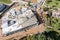 Builders pouring wet concrete, using hose from concrete pumping machine into floor slab form. aerial view