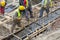 Builders working on concreting formwork for the foundation