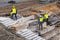 Builders working on construction foundation. Man strengthen concrete structure on the hill slope