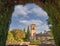 Building of the Alhambra viewed through an arch carved in a tree in the gardens of the Alhambra in Granada, Andalusia, Spain.