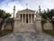 The building of the Athens Academy a marble column with a sculptures of Apollo and Athena, Socrates and Plato against a with