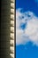 Building with balcony silhouetted against clouds in the sky