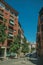 Building with bricks facade and trees on a quiet street in Madrid