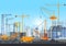 Building city under construction website with tower cranes. Building work process with houses and construction machines