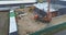 Building construction aerial view. Excavator on a construction site, workflow at a construction site, people work on a