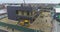 Building construction aerial view. Excavator on a construction site, workflow at a construction site, people work on a