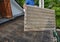 A building contractor is removing old harmful and dangerous for health corrugated asbestos roof tile, sheet from a roof leaving