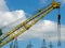 Building crane detail against blue sky