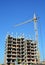 Building cranes on construction site with builders. Building high rise.Crane Construction. Tower Crane and Building Constructors