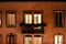 Building facade with illuminated apartment window