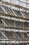 Building facade with scaffolding under renovation in sunlight