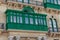 Building facade with traditional balconies in Valletta, Malta