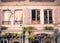 Building facade with windows, shutters and plants from old building in France