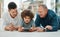 Building a familial bridge through technology. a young man spending time with his father and son while using a digital