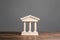 Building figurine with pillars in antique style. Concept of city administration, bank, university, court or library. Architectural