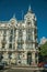 Building with flamboyant facade and people on street of Madrid