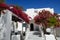 Building of hotel in traditional Greek style and Bougainvillea flowers, Santorini island