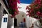 Building of hotel in traditional Greek style and Bougainvillea flowers, Santorini island