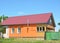 Building house with metal roof, steel gas chimney, wooden veranda, plastering