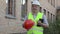Building inspector with helmet for worker