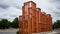 A building made of wooden blocks on the side of a road. AI.