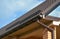 Building Modern House Construction with metal roof corner, rain gutter system and roof protection from snow