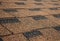 Building new house with asphalt shingle roof. Close up on brown roof shingles as a textured background