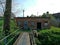 Building old and abandoned, standing by the bridge, its windows are closed by sheets steel