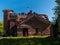 The building of the old stables of red brick in the English style with a round turret and extensions