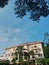 Building, plants, blue sky and the coconut tree