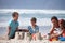 Building sandcastles- one of lifes simple pleasures. Shot of a happy family building sandcastles together at the beach.