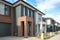 Building of some residential townhouses in a suburb of Australia. The exteriors of some two-story modern Australian suburban homes