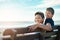 Building strong bonds on the beach. Portrait of two happy brothers sitting on a bench by the beach together.