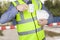 Building surveyor in hi vis with hard hat having a coffee break