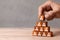 Building team. The leader builds pyramid from cubes with employees. Recruitment concept