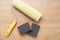 Building tools for painting surfaces. Painting roller and sandpaper on wooden background