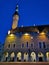 The building of the Town Hall with an illuminated spire on the Town Hall Square against the blue sky. Old Tallinn