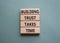 Building Trust takes Time symbol. Wooden blocks with words Building Trust takes Time. Beautiful grey green background. Business