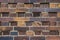 Building wall made of dark, yellow to brownish clinker bricks with various alternating patterns. The stones are offset in rows,